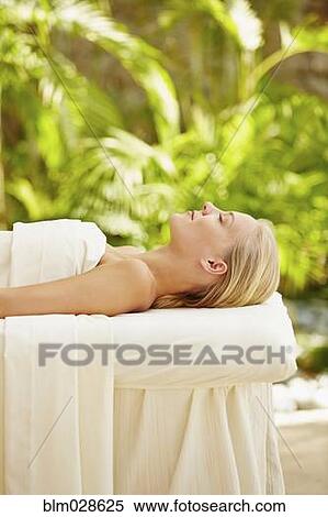 Caucasian woman laying on massage table View Large Photo Image Stock Photography - Caucasian woman laying on massage table. Fotosearch