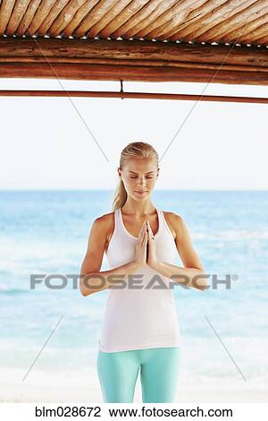 Caucasian woman meditating in cabana overlooking ocean View Large Photo Image Stock Image - Caucasian woman meditating in cabana overlooking ocean. Fotosearch