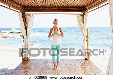 Caucasian woman meditating in cabana overlooking ocean View Large Photo Image Stock Photo - Caucasian woman meditating in cabana overlooking ocean. Fotosearch