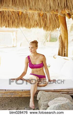 Caucasian woman relaxing in cabana View Large Photo Image Stock Photograph - Caucasian woman relaxing in cabana. Fotosearch