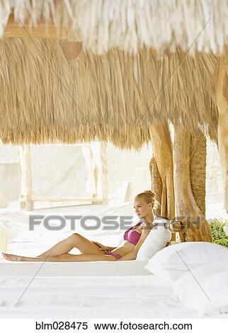 Caucasian woman relaxing in cabana View Large Photo Image Stock Photography - Caucasian woman relaxing in cabana. Fotosearch