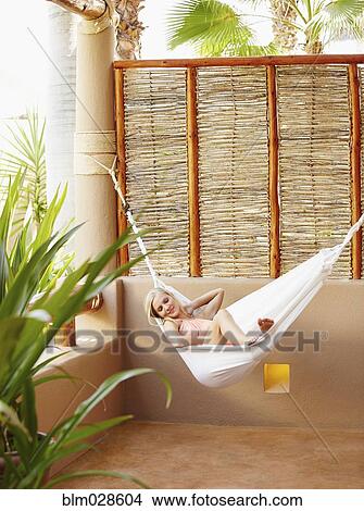 Picture - Caucasian woman relaxing in hammock. Fotosearch