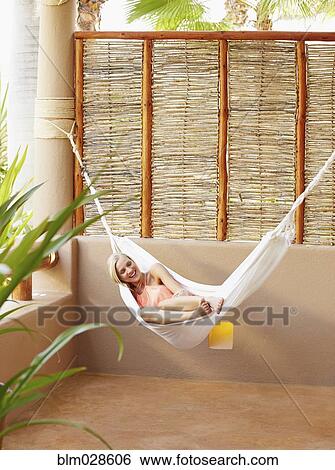 Caucasian woman relaxing in hammock View Large Photo Image Stock Photograph - Caucasian woman relaxing in hammock. Fotosearch