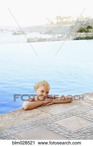 Caucasian woman relaxing in infinity pool View Large Photo Image Stock Image - Caucasian woman relaxing in infinity pool. Fotosearch