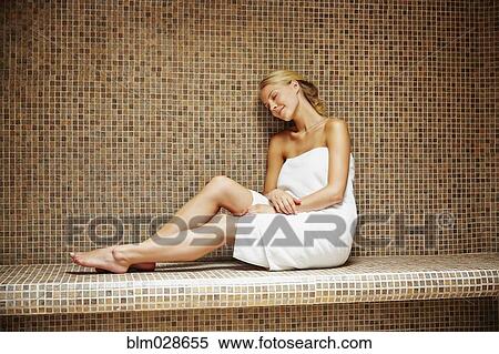 Stock Photography - Caucasian woman relaxing in sauna. Fotosearch