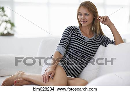 Caucasian woman relaxing on sofa View Large Photo Image Picture - Caucasian woman relaxing on sofa. Fotosearch