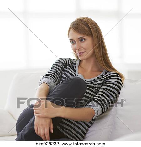 Caucasian woman relaxing on sofa View Large Photo Image Stock Image - Caucasian woman relaxing on sofa. Fotosearch