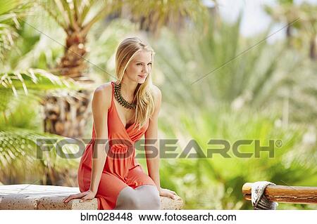 Caucasian woman sitting outdoors View Large Photo Image Stock Photo - Caucasian woman sitting outdoors. Fotosearch