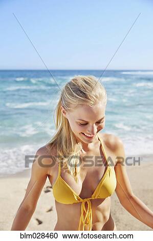Stock Image - Caucasian woman smiling on beach. Fotosearch
