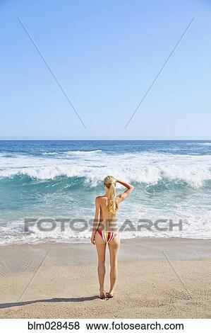 Caucasian woman standing on beach View Large Photo Image Stock Photo - Caucasian woman standing on beach. Fotosearch