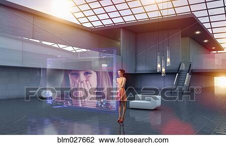 Stock Image - Caucasian woman using hologram computer screen. Fotosearch