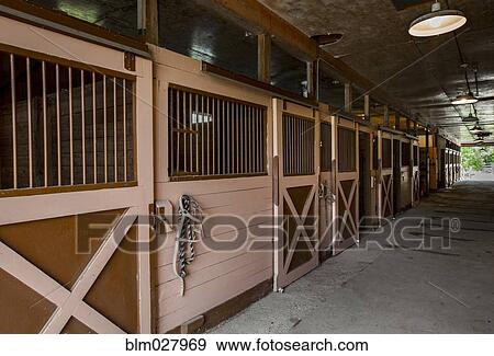 Stock Photo - Closed stables in barn. Fotosearch
