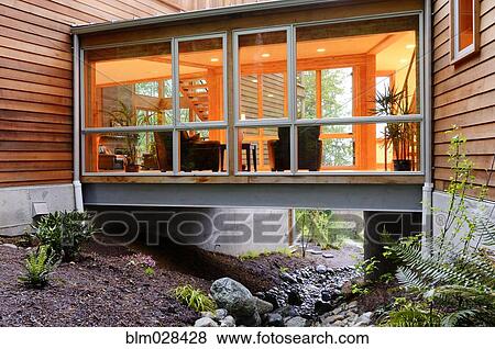 Stock Photo - Corridor of modern house built over rocky creek. Fotosearch