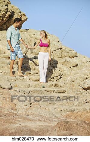 Couple climbing rocky steps View Large Photo Image Stock Image - Couple climbing rocky steps. Fotosearch