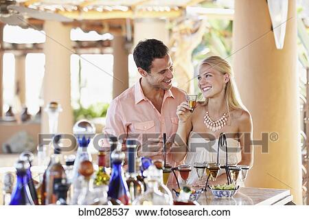 Stock Photo - Couple drinking tequila in bar. Fotosearch