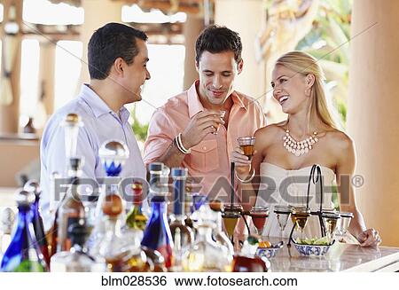 Stock Photograph - Couple drinking tequila in bar. Fotosearch