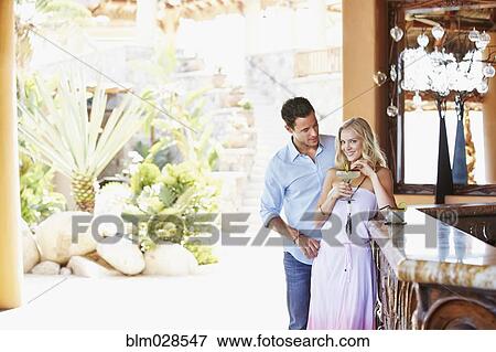 Stock Photo - Couple having margarita together at bar. Fotosearch