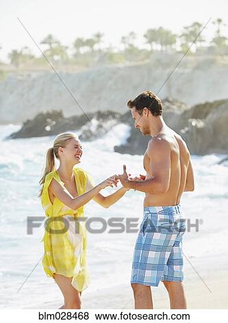 Couple holding hands on beach View Large Photo Image Stock Photo - Couple holding hands on beach. Fotosearch