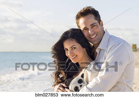 Couple hugging on beach View Large Photo Image Stock Image - Couple hugging on beach. Fotosearch
