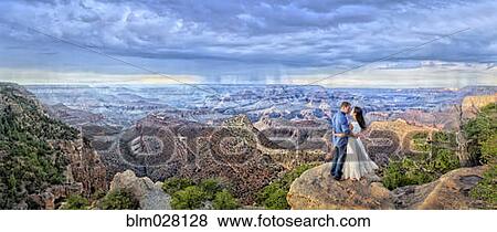 Couple overlooking Grand Canyon, Arizona, United States View Large Photo Image Stock Photo - Couple overlooking Grand Canyon, Arizona, United States. Fotosearch
