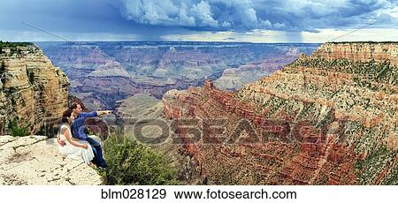 Couple overlooking Grand Canyon, Arizona, United States View Large Photo Image Stock Photo - Couple overlooking Grand Canyon, Arizona, United States. Fotosearch