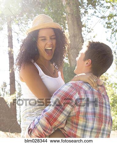 Picture - Couple playing in woods. Fotosearch