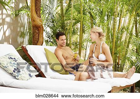Picture - Couple relaxing in lounge chairs. Fotosearch