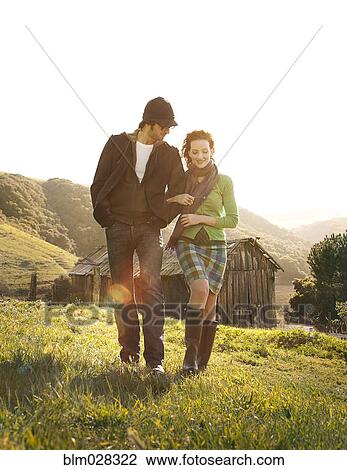 Couple walking in rural landscape View Large Photo Image Stock Image - Couple walking in rural landscape. Fotosearch