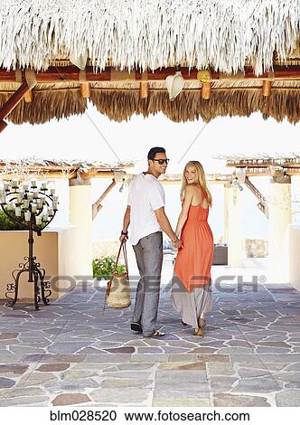 Couple walking under awning outdoors View Large Photo Image Stock Image - Couple walking under awning outdoors. Fotosearch