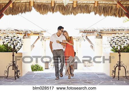 Stock Photo - Couple walking under awning outdoors. Fotosearch