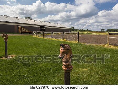 Decorative horse posts on farm View Large Photo Image Stock Image - Decorative horse posts on farm. Fotosearch