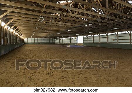 Stock Image - Empty indoor horse riding ring. Fotosearch