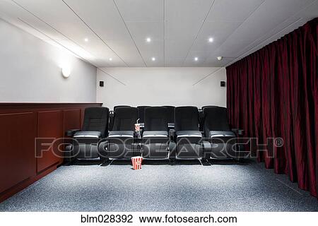 Stock Image - Empty seats in home theater. Fotosearch