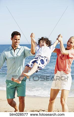 Family playing together on beach View Large Photo Image Stock Photo - Family playing together on beach. Fotosearch