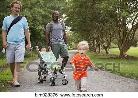 Fathers and sons walking together in park View Large Photo Image Stock Photograph - Fathers and sons walking together in park. Fotosearch