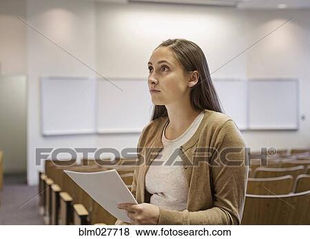 Female student holding essay in lecture hall View Large Photo Image Stock Photo - Female student holding essay in lecture hall. Fotosearch