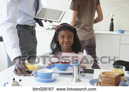 Girl smiling at breakfast table View Large Photo Image Stock Photo - Girl smiling at breakfast table. Fotosearch