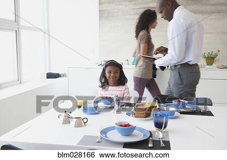 Girl smiling at breakfast table View Large Photo Image Stock Photograph - Girl smiling at breakfast table. Fotosearch
