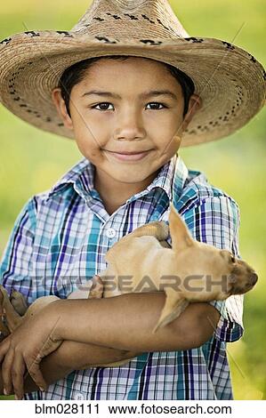 Hispanic boy holding puppy outdoors View Large Photo Image Stock Image - Hispanic boy holding puppy outdoors. Fotosearch