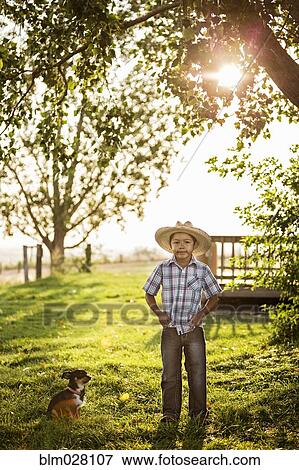 Stock Photo - Hispanic boy standing outdoors. Fotosearch