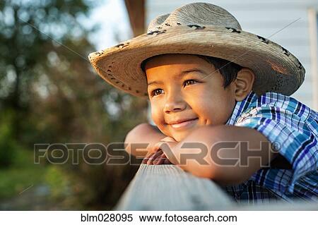 Stock Photography - Hispanic boy wearing cowboy hat outdoors. Fotosearch