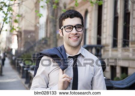 Hispanic businessman walking on city sidewalk View Large Photo Image Stock Image - Hispanic businessman walking on city sidewalk. Fotosearch