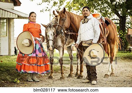 Stock Photo - Hispanic couple in traditional clothing outdoors. Fotosearch