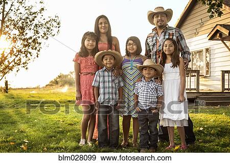 Stock Photo - Hispanic family smiling together outdoors. Fotosearch