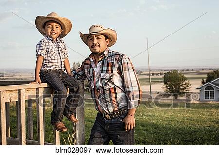 Hispanic father and son wearing cowboy hats outdoors View Large Photo Image Stock Photo - Hispanic father and son wearing cowboy hats outdoors. Fotosearch
