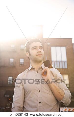 Stock Image - Hispanic man in city. Fotosearch