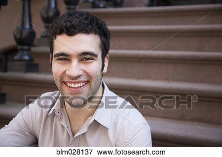 Hispanic man smiling on front steps View Large Photo Image Stock Photo - Hispanic man smiling on front steps. Fotosearch