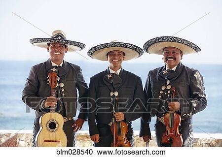 Stock Image - Hispanic mariachi band smiling together. Fotosearch