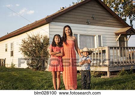 Hispanic mother and children smiling outside house View Large Photo Image Stock Image - Hispanic mother and children smiling outside house. Fotosearch