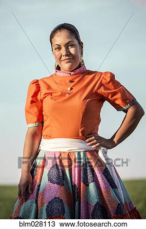 Stock Image - Hispanic woman in traditional garb outdoors. Fotosearch